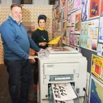 Gabriella Marcella and Daniel Bridgeman stood with the RISO printer
